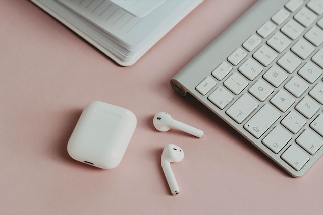 AirPods on pink desk