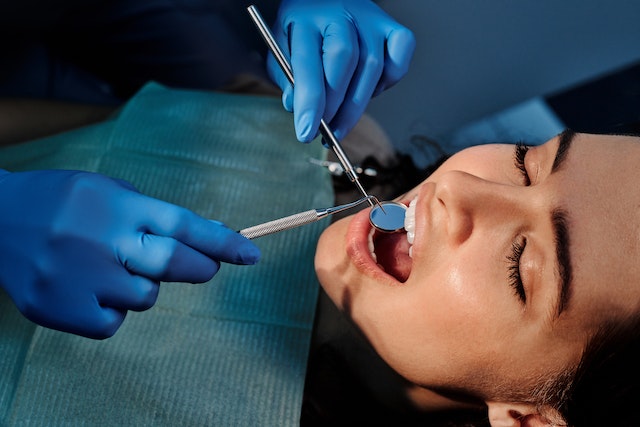 a person at an orthodontist checks his teeth