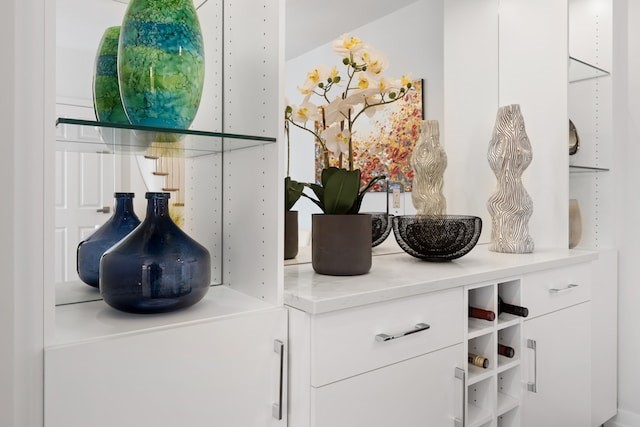 A white shelf filled with vases and other decorative items
