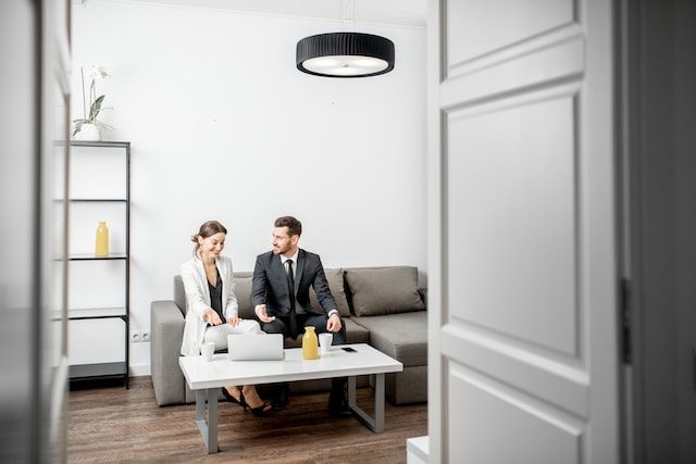 Elegant businessman and woman sitting together