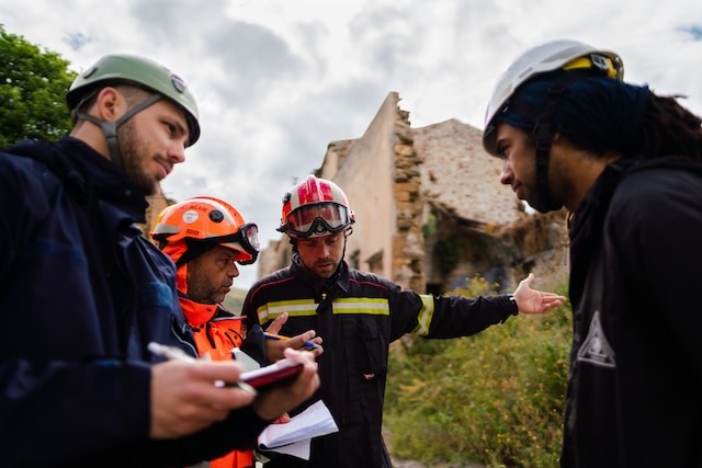 men in blue and orange jacket wearing helmet