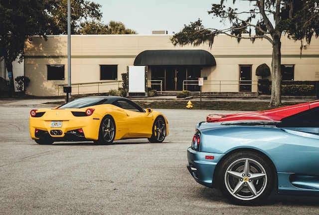 three Lamborghini coupes near building