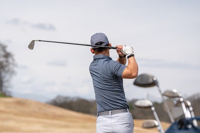 a man swinging a golf club on a golf course