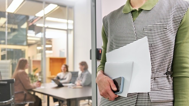 a person holding a folder in a meeting room