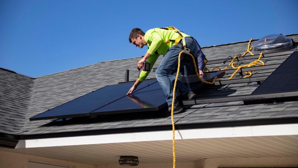 person installing solar panel