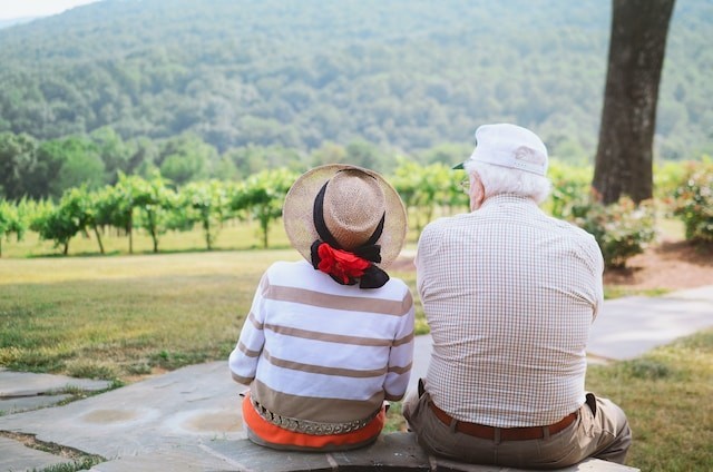 eldery couple sitting on pathway