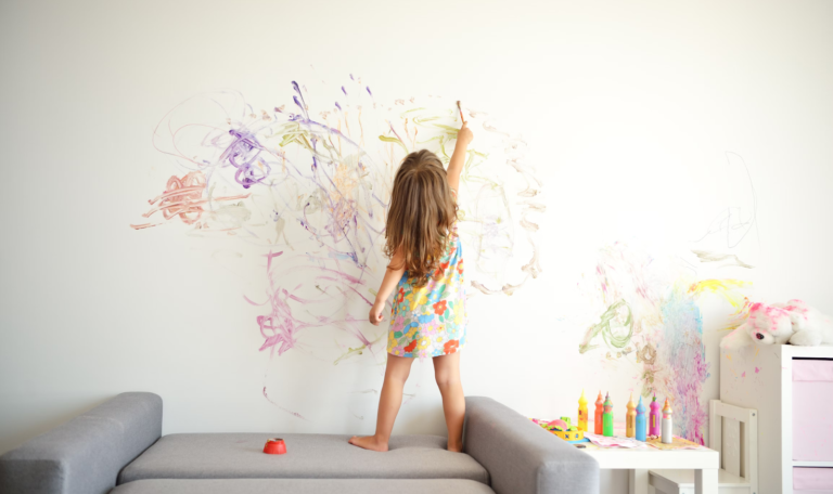 a child draws on the wallpaper